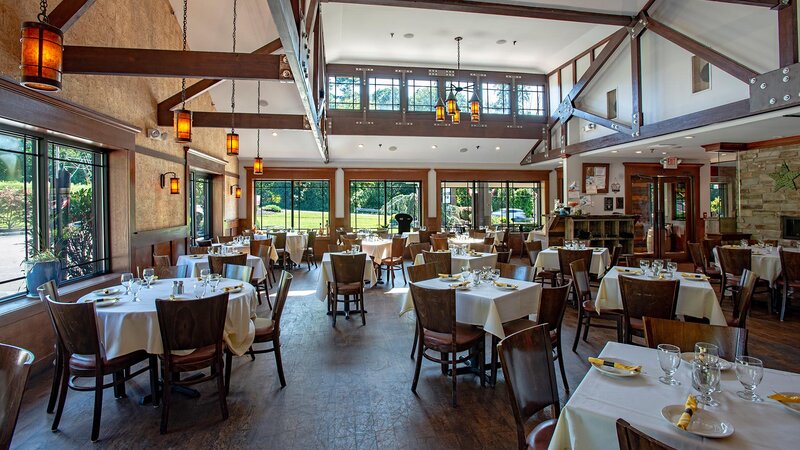 Set tables with white table cloths in side dining room