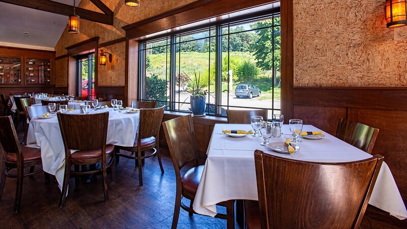 Side dining room with tables set for four and six